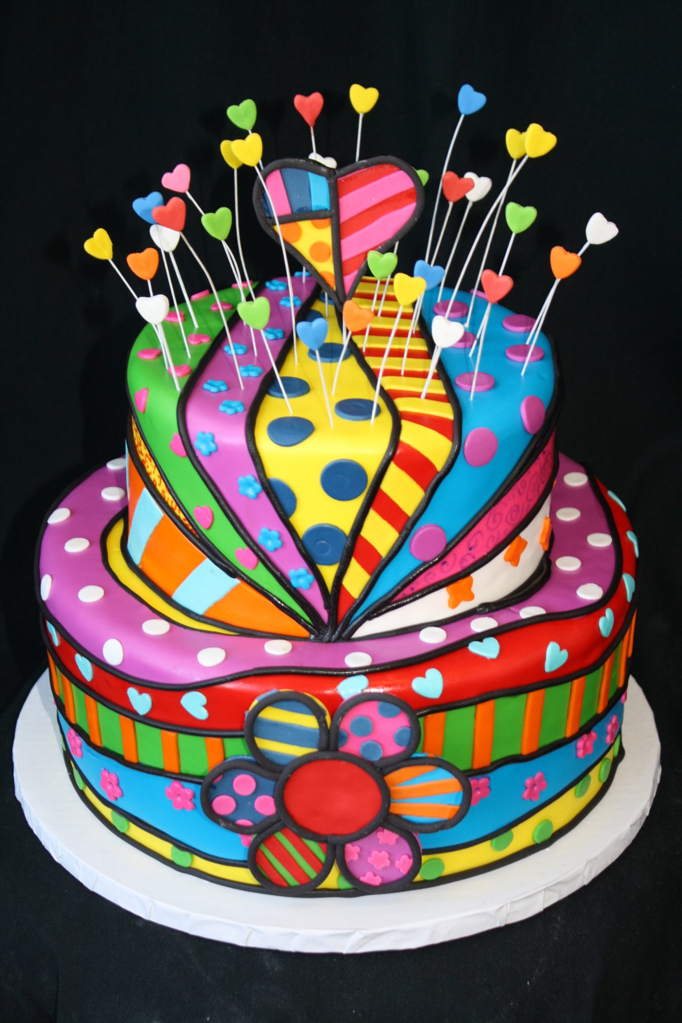 Colorful pop-art birthday cake with sugar hearts