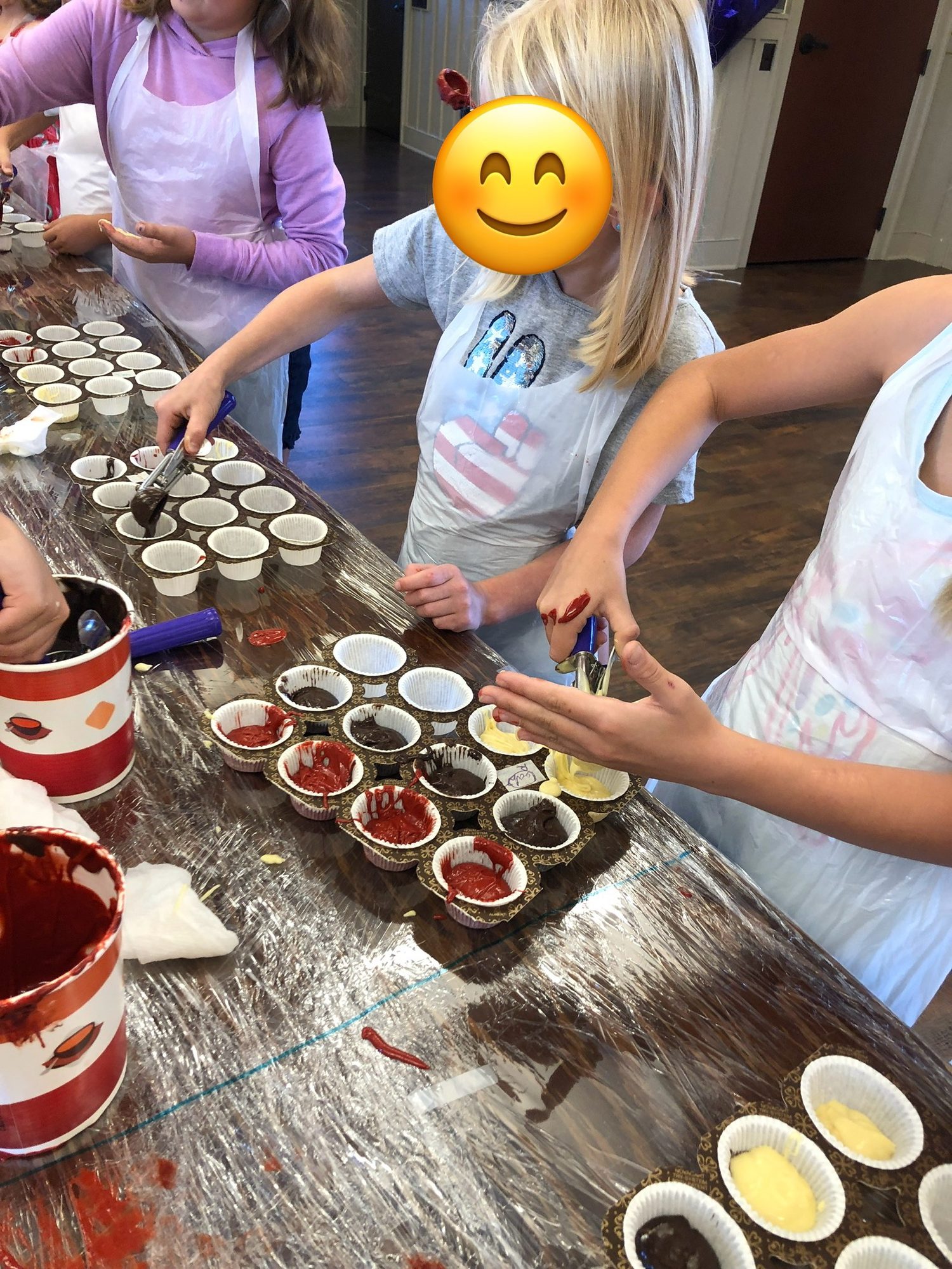 Filling cupcake liners at a baking party