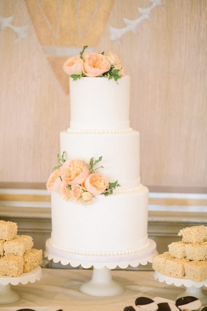 Three-tier wedding cake with peach roses