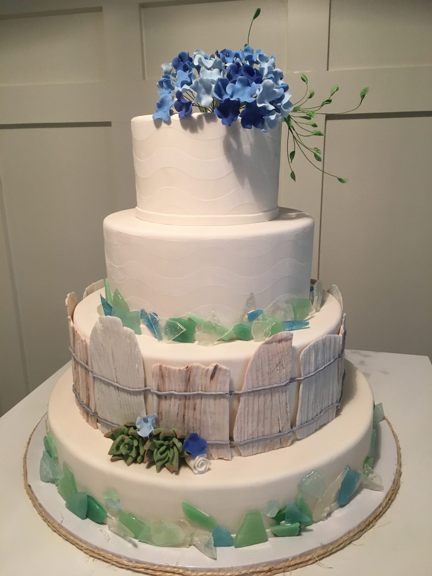 Wedding cake with a picket fence and sugar succulents