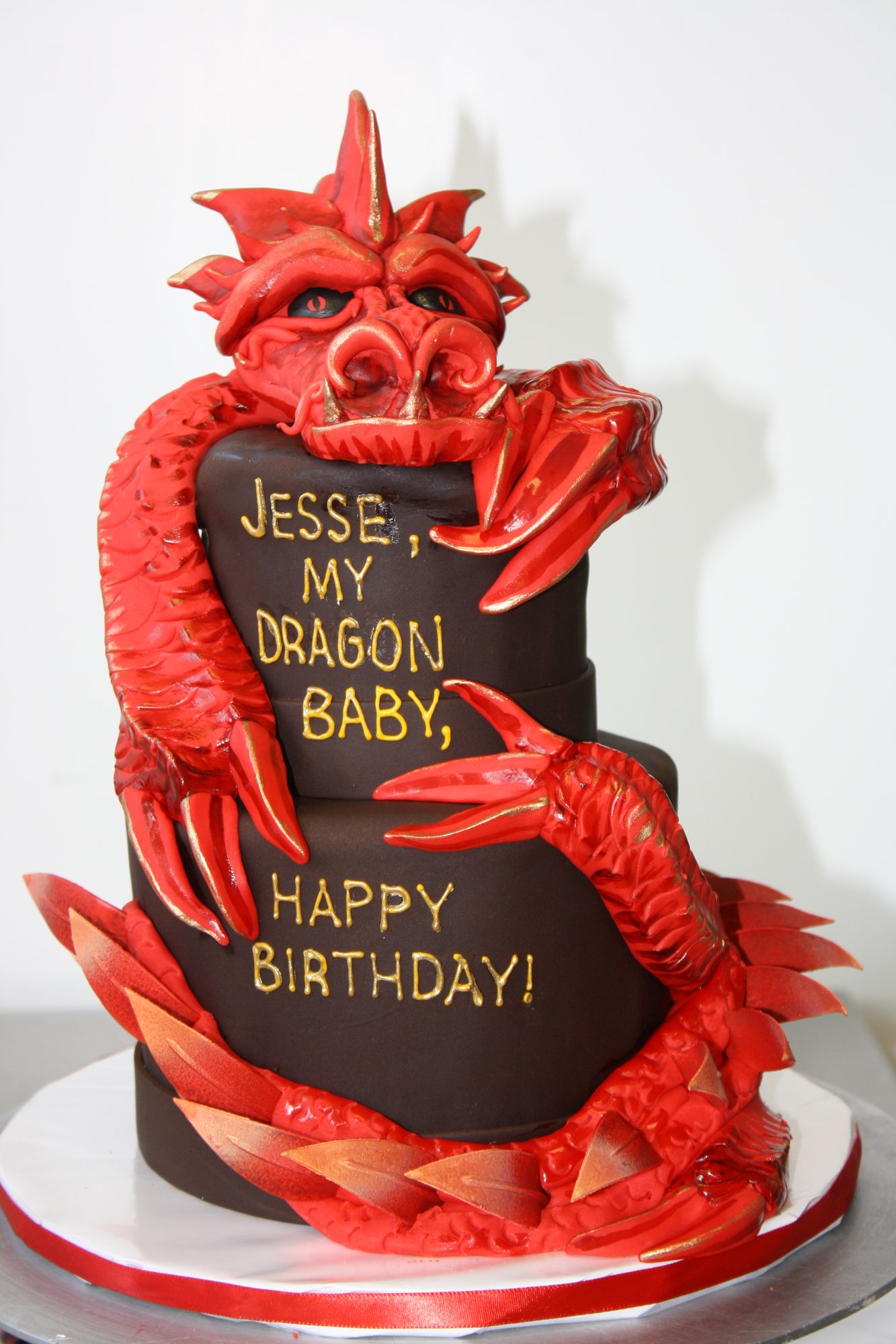 Two-tier cake with a sculpted red dragon